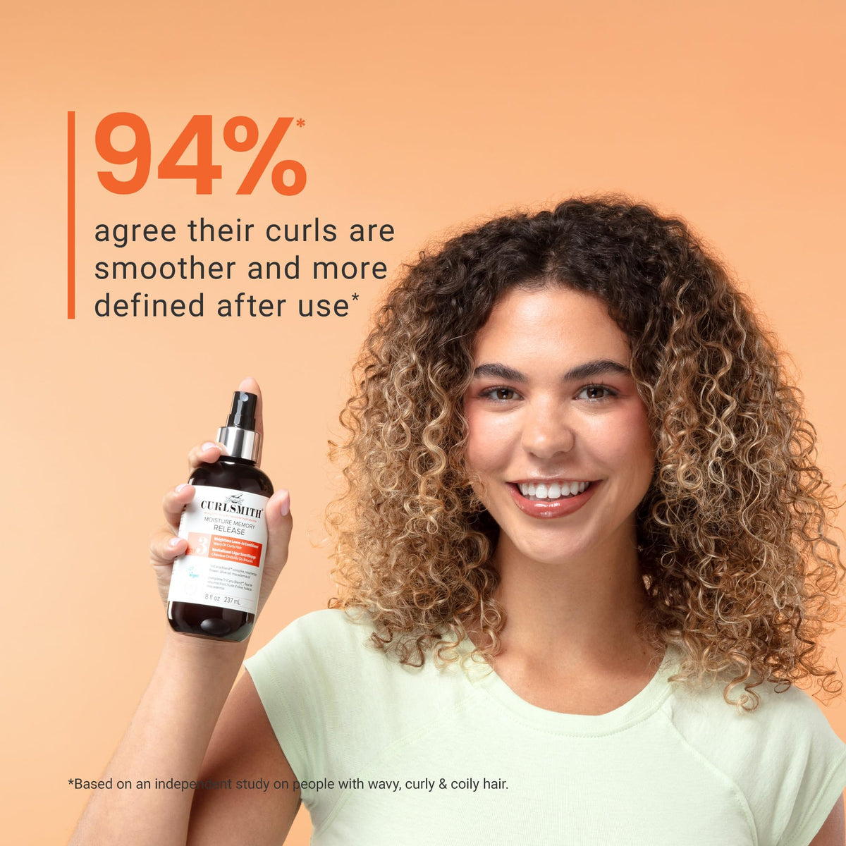 CURLSMITH bottle in hand for size scale and travel-friendly benefit