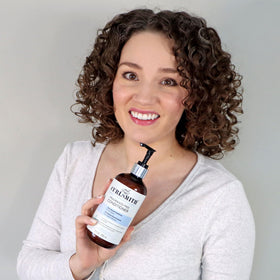 CURLSMITH product label close-up showing ingredients and dermatological testing benefit
