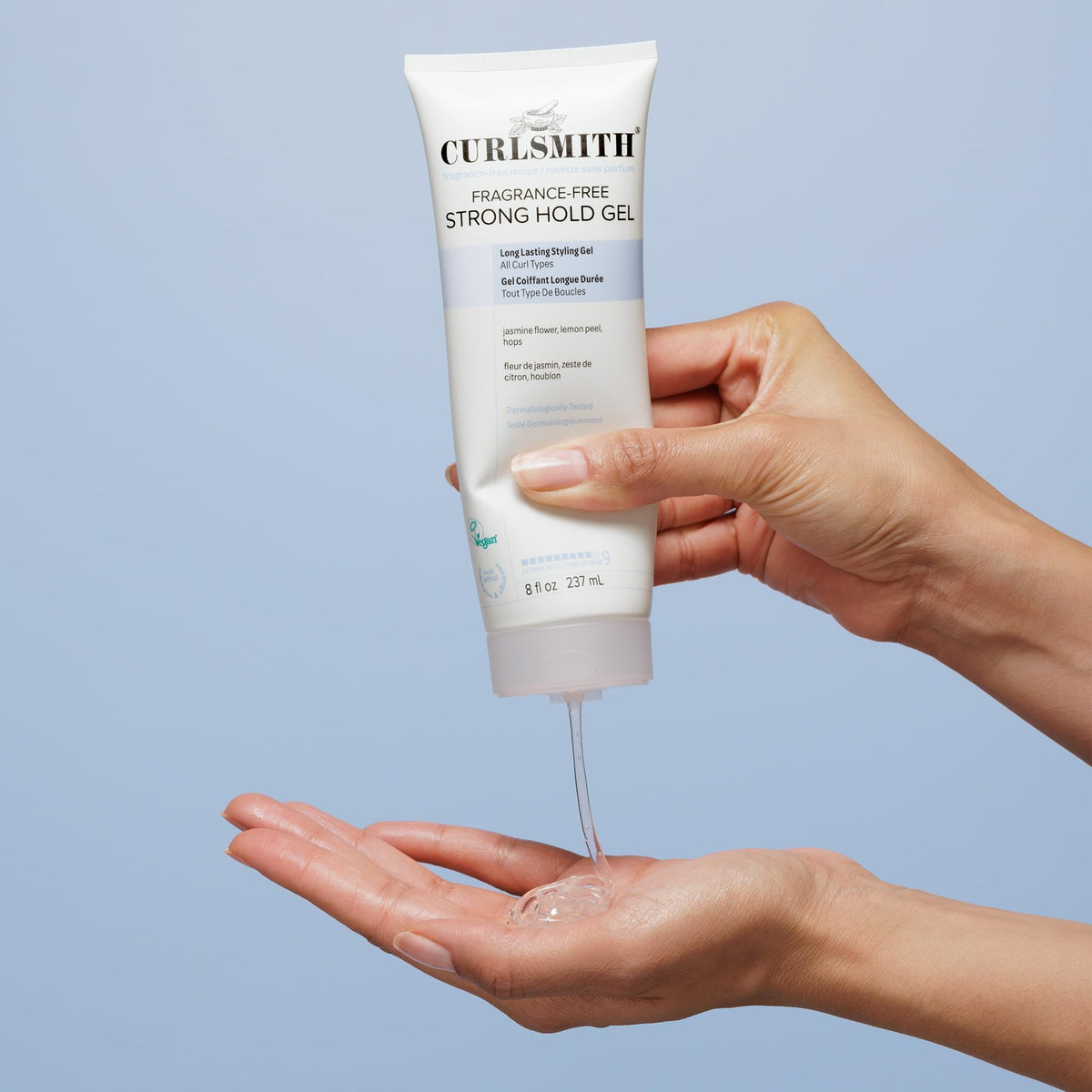 CURLSMITH 8 oz bottle in hand showing scale and travel-friendly size
