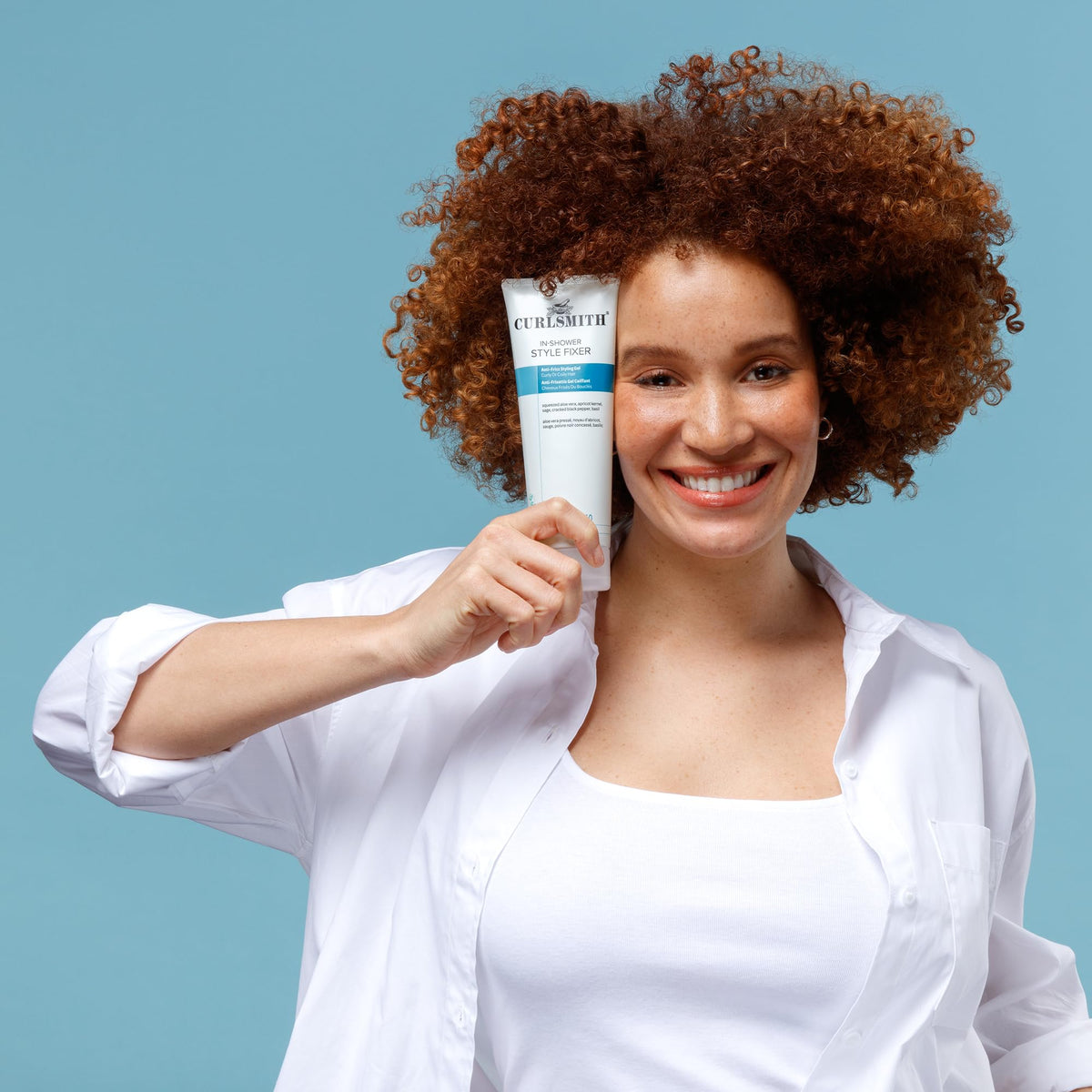 CURLSMITH bottle in hand showing 8 oz scale and travel-friendly size