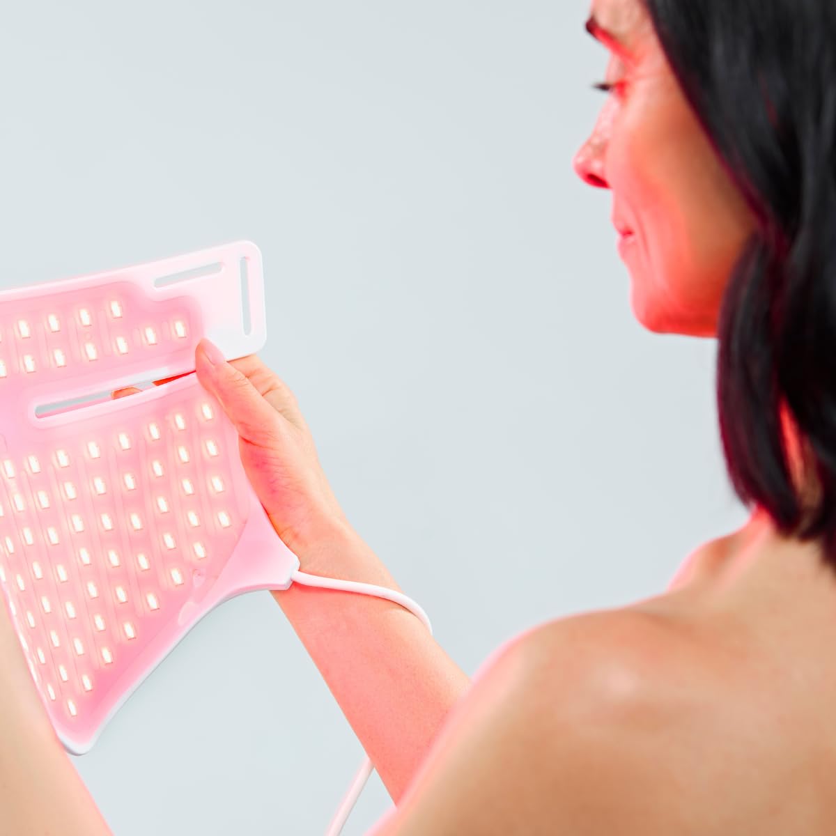 CurrentBody mask worn on model showing neck and chest coverage and benefit of targeted light therapy