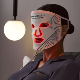 CurrentBody mask beside a hand to show scale and portability benefit