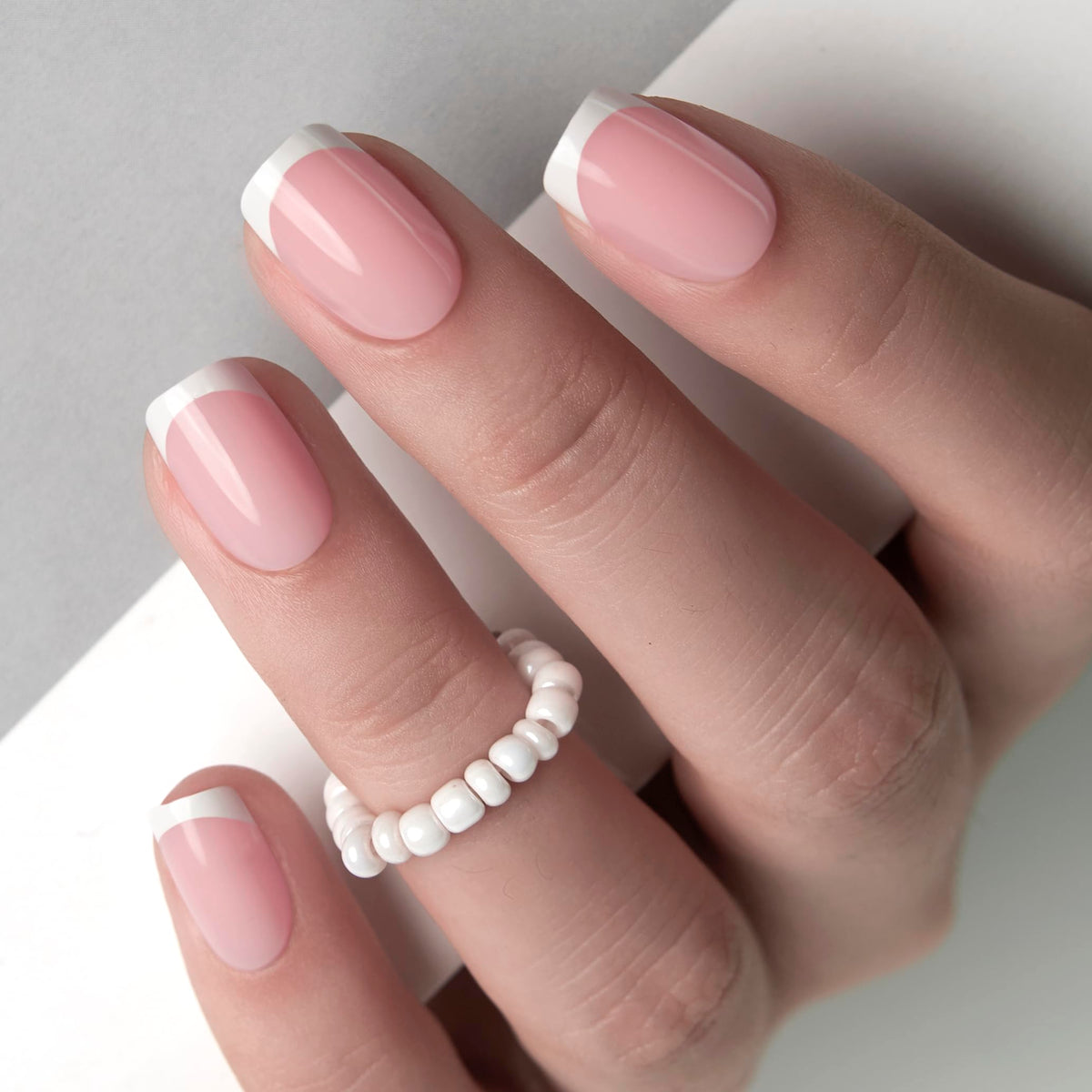 Curvlife close-up of handmade gel French tip pattern highlighting salon finish