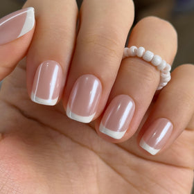 Curvlife front view of boxed short square pearl French nails showing glossy finish and polish benefit