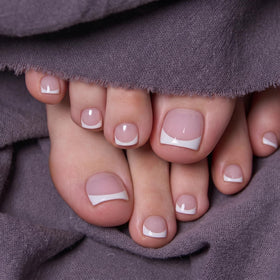 Hand holding a toe nail from CurvLife Grace Line displaying size and short square shape for fit comparison