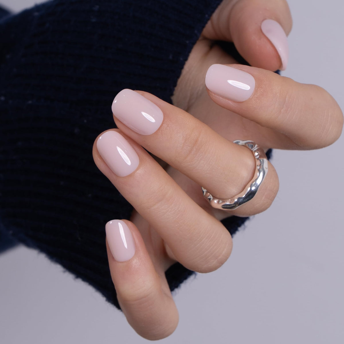 CurvLife in hand scale comparison illustrating size and realistic nail length benefit