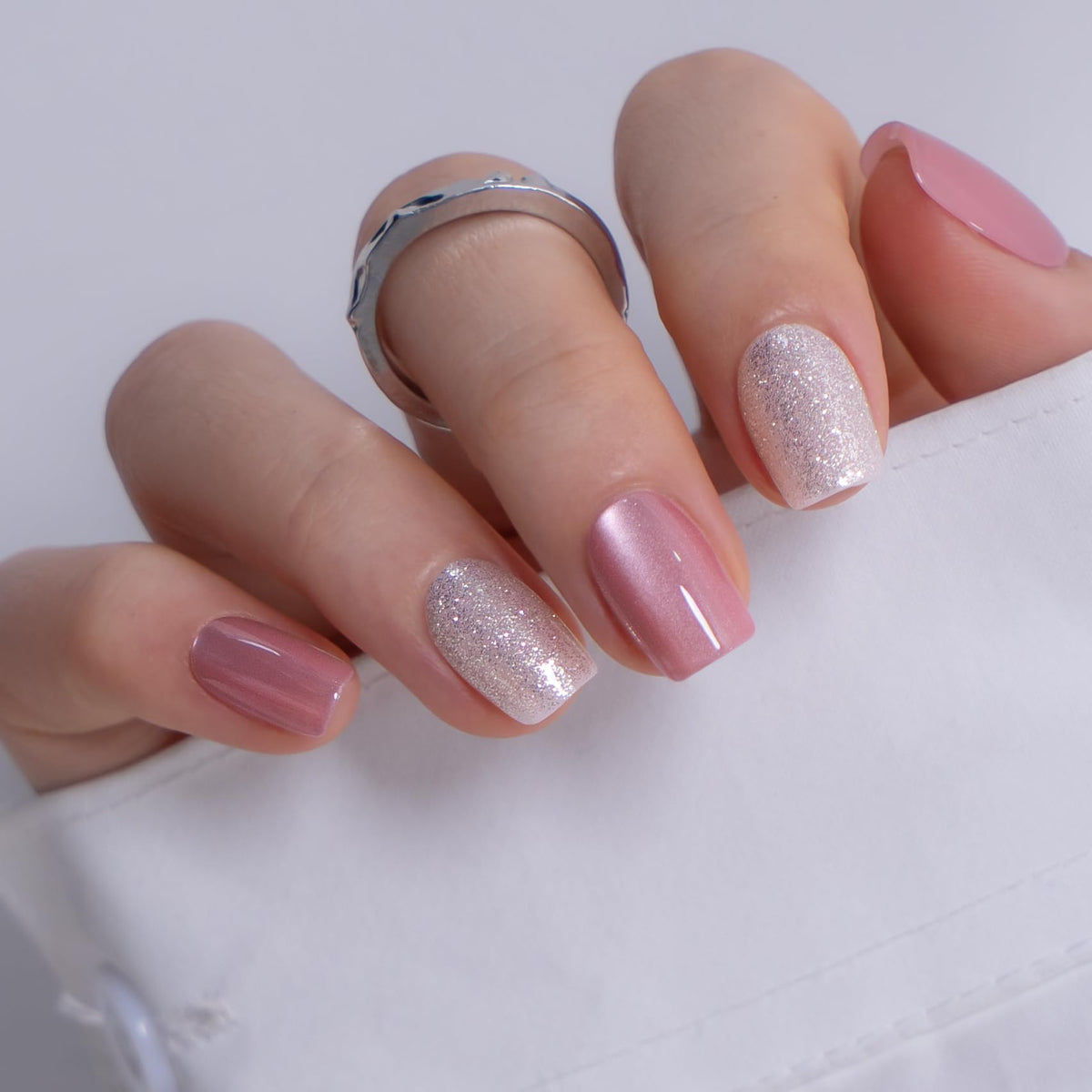 CurvLife nails held in hand showing scale and natural short square look
