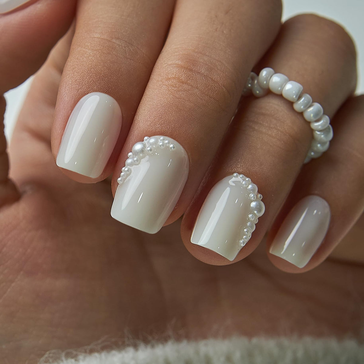 Curvlife nails on hand for scale demonstrating natural short square fit