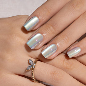 CurvLife nails held to show scale and short full-cover fit on natural nail
