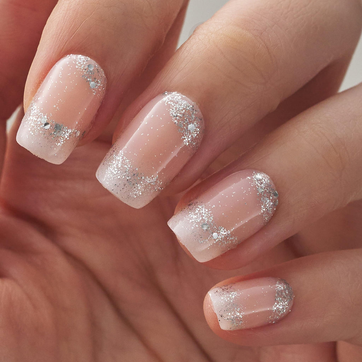 CurvLife nails on hand demonstrating comfortable medium square French diamond style