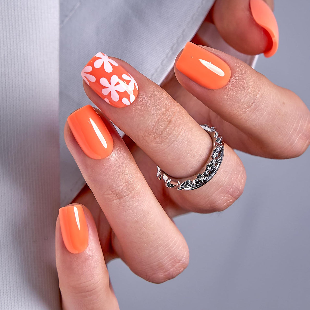 CurvLife front view of orange flower press-on nails showing full-set polished finish and convenience