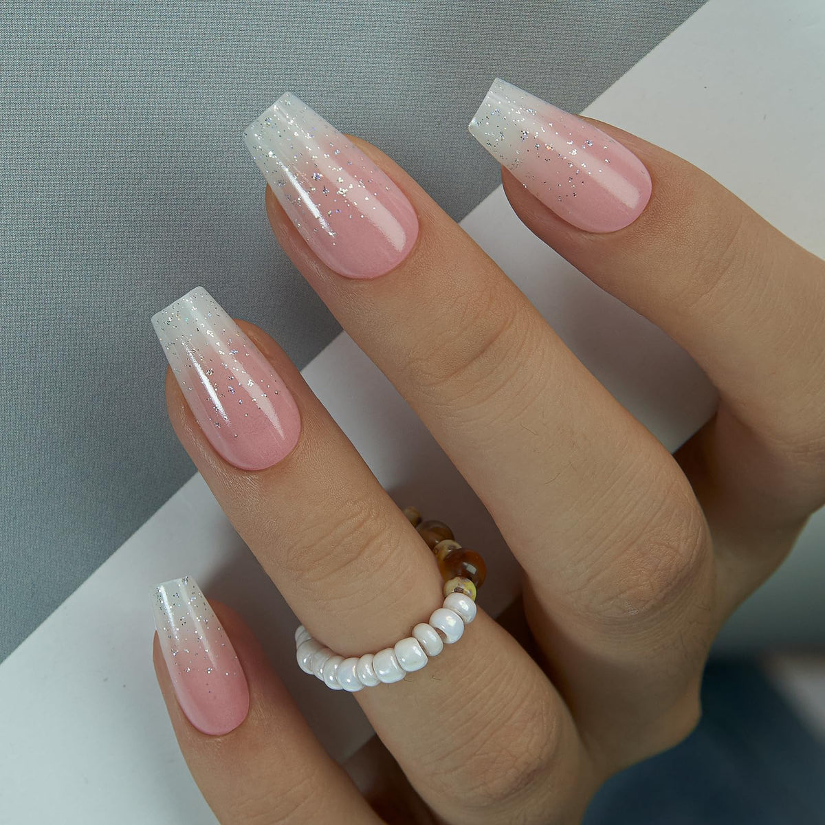 CurvLife nails in hand to show short square size and natural-looking fit benefit