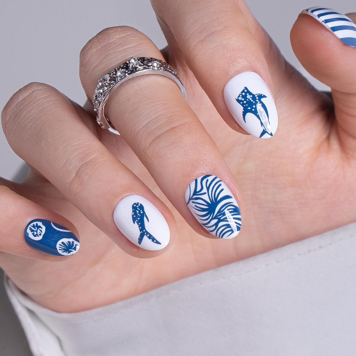 CurvLife nails held in hand showing scale and natural-fit benefit