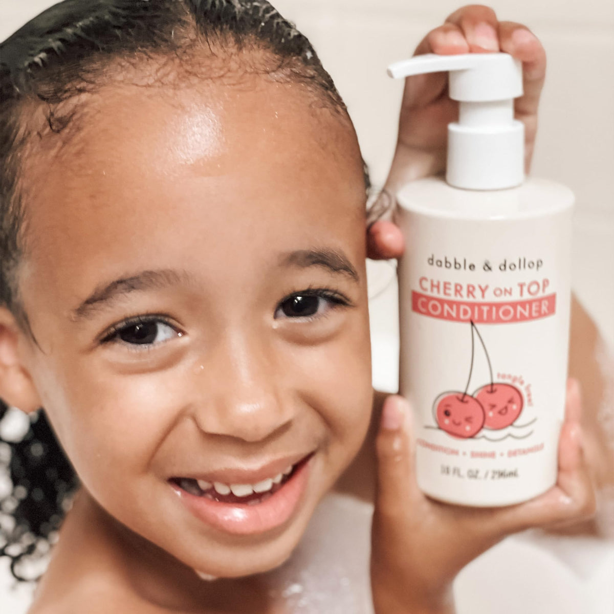 Child in bath with Dabble & Dollop being applied, making brushing easier