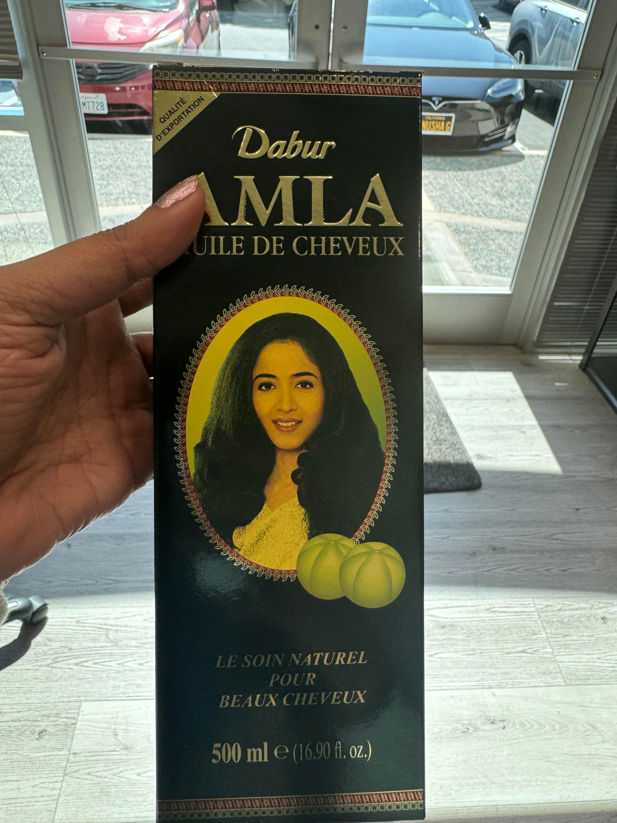 Dabur amla hair oil pouring texture highlighting smooth, lightweight consistency