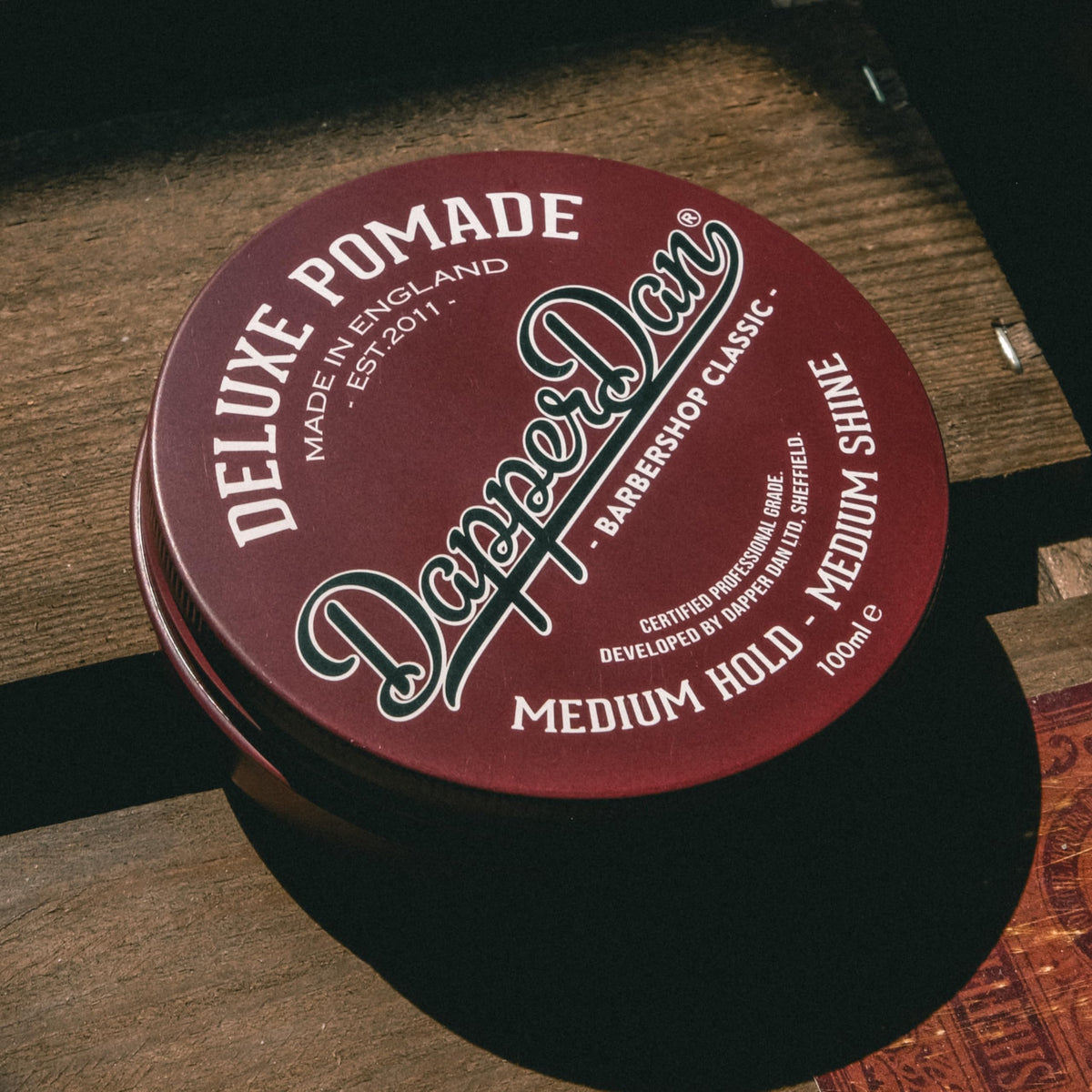 Dapper Dan 100ml jar next to ruler showing compact size for travel