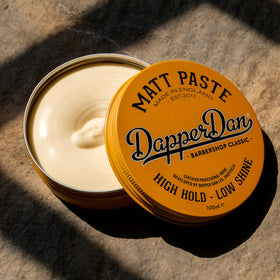 Dapper Dan paste in hand being warmed for smooth application and even hold