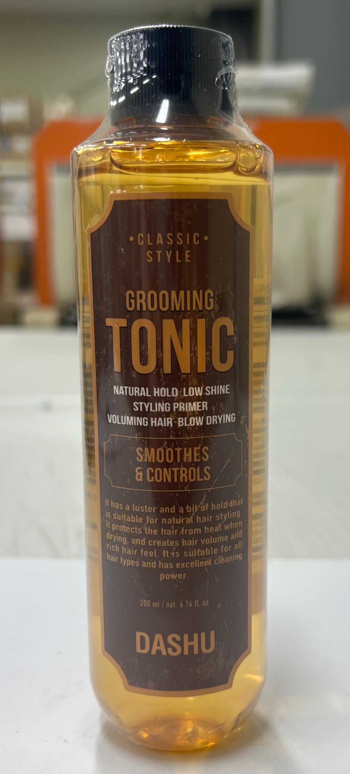 Applying DASHU tonic to towel-dried hair to boost root lift and heat protection