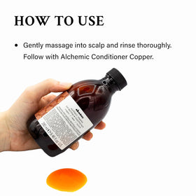 Applying Davines Alchemic Shampoo Copper on red hair to boost copper tones and shine