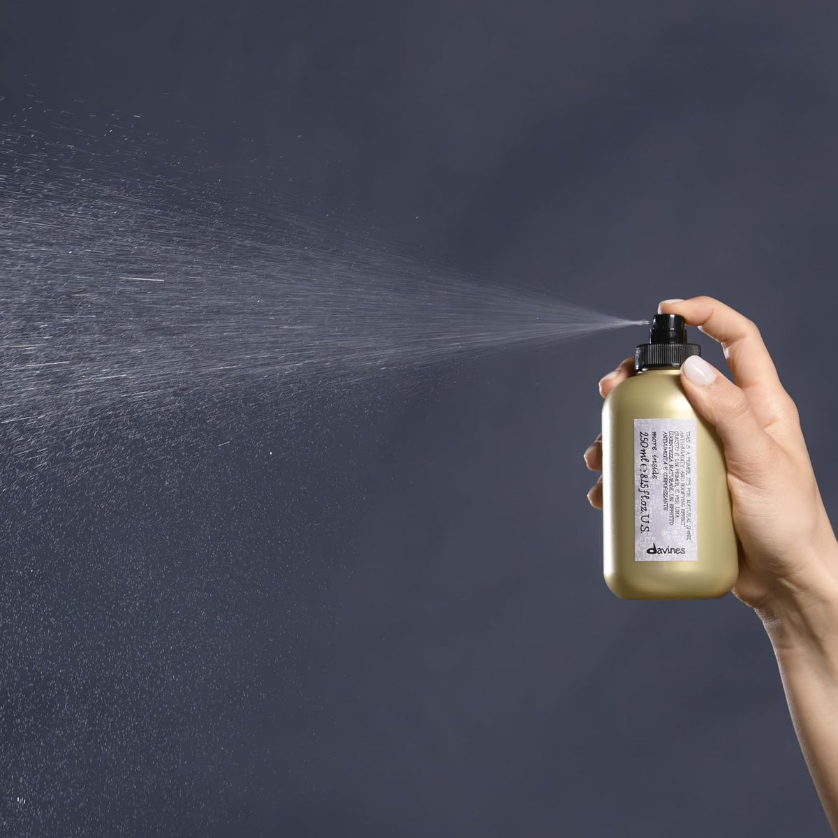 Davines being applied to towel-dried hair, prepping strands for faster blow-dry and volume