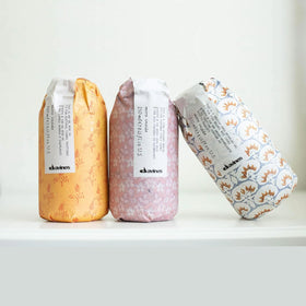 Davines gel surrounded by botanical elements suggesting natural-derived ingredients benefit