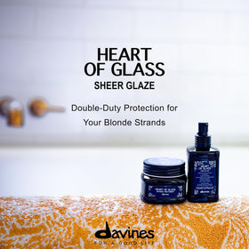 Applying Davines Sheer Glaze in hand before blowdry for protection