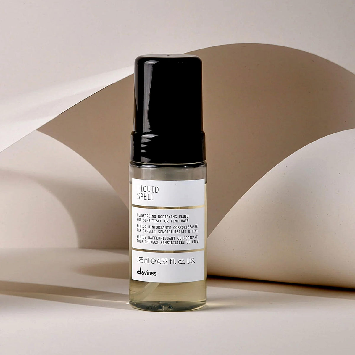 Davines bottle beside passport showing travel-sized convenience