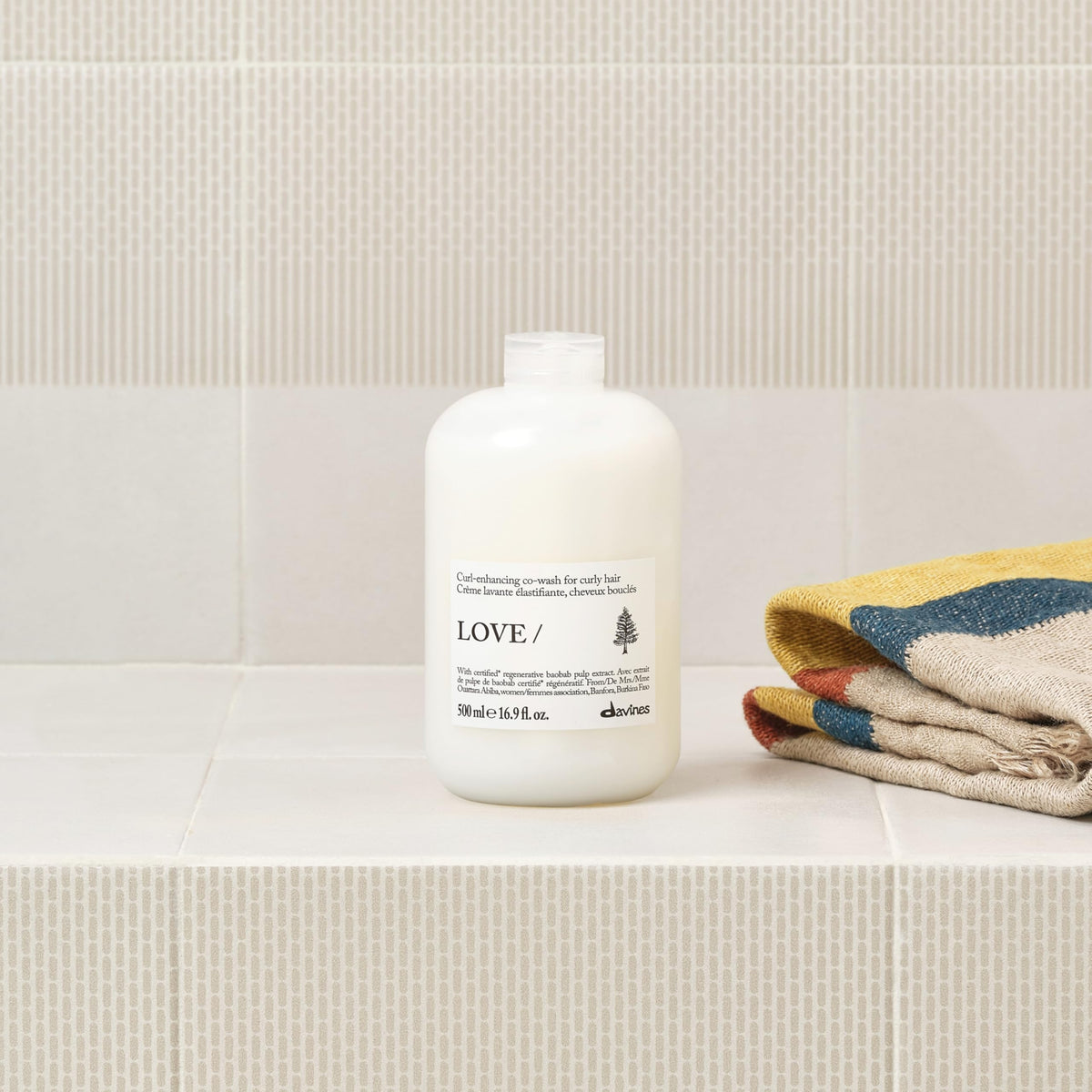 Davines product being poured onto hand for easy-to-apply curl cleansing