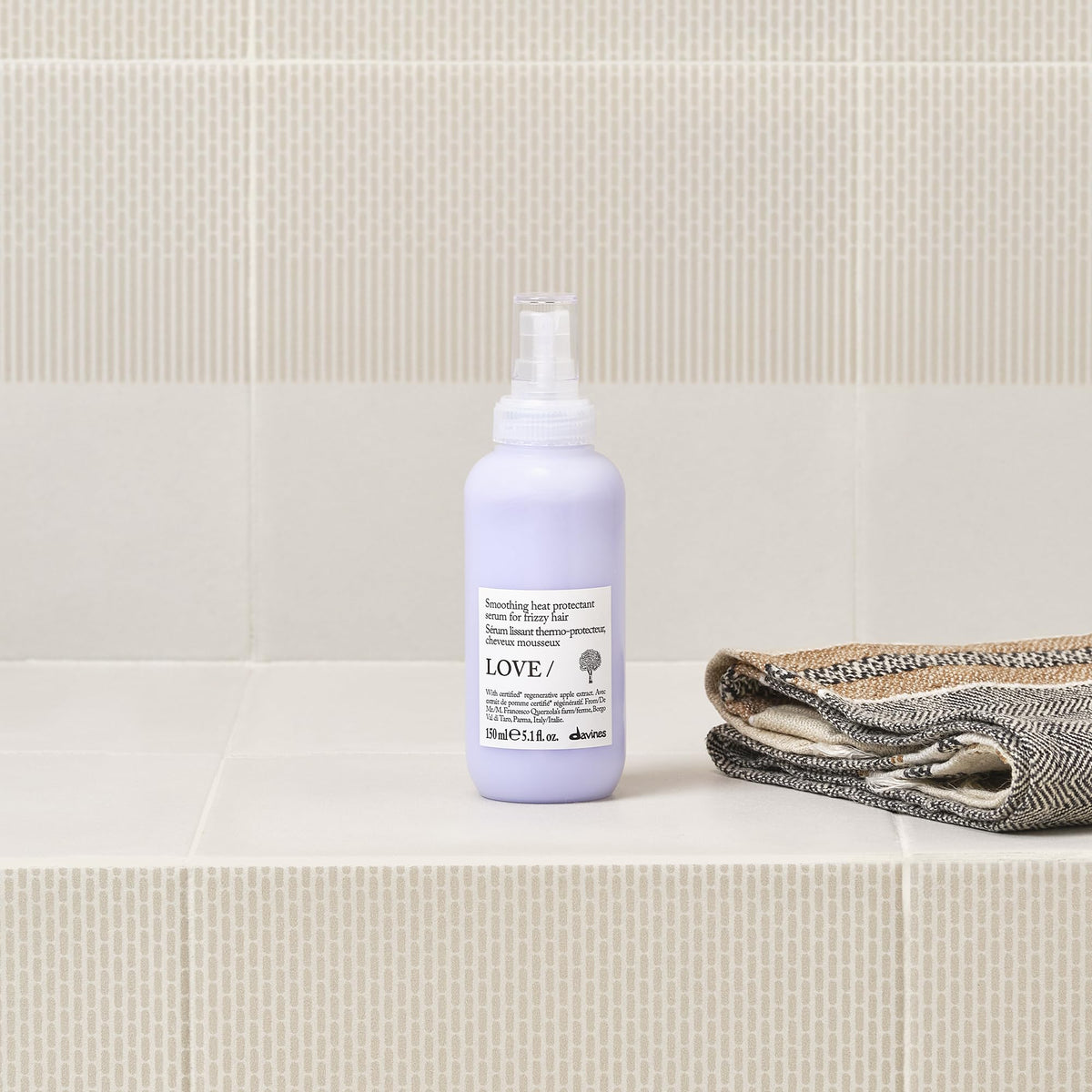 Davines application on hair strand smoothing frizz and improving manageability