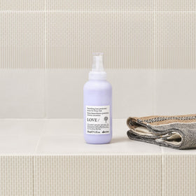 Davines application on hair strand smoothing frizz and improving manageability