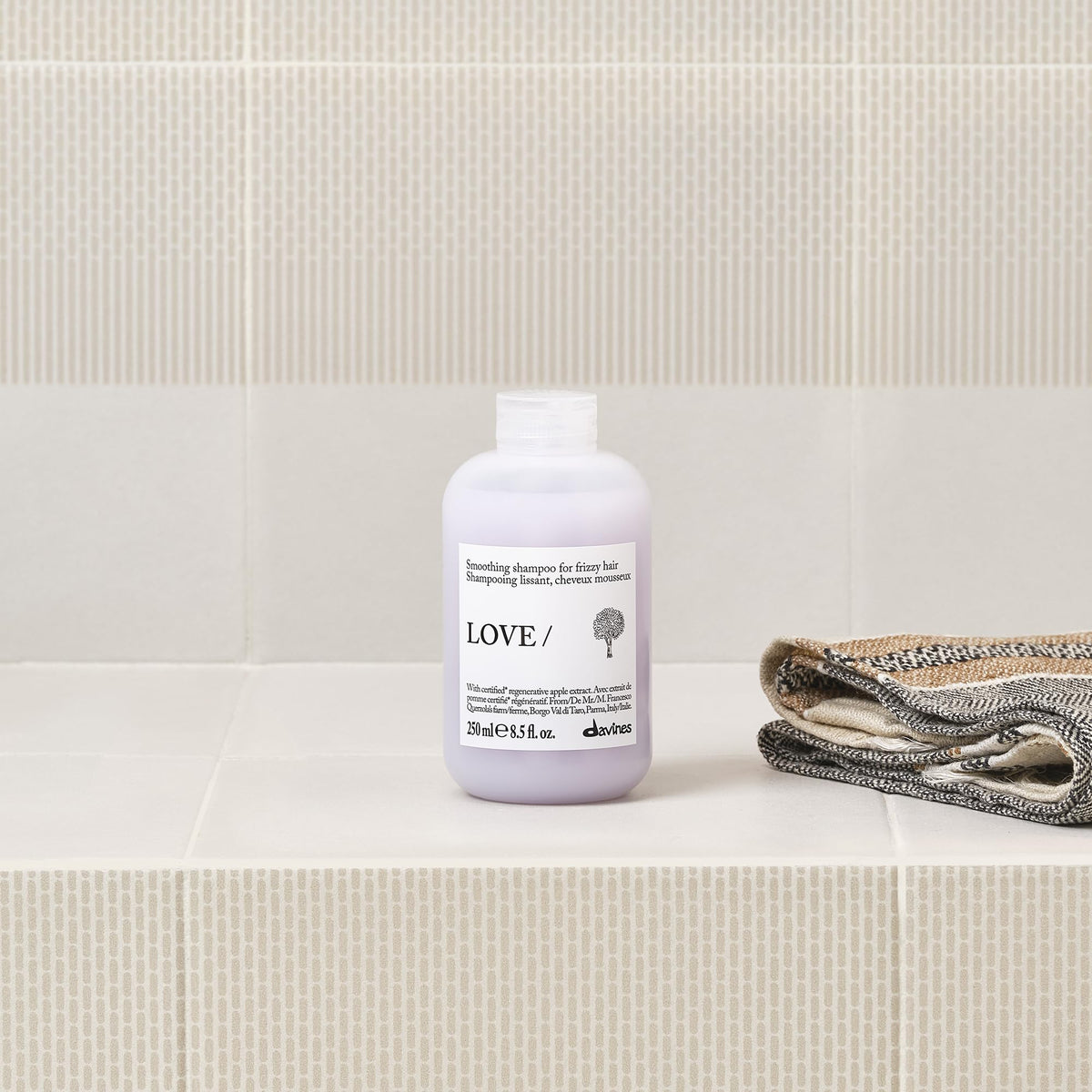 Davines bottle in hand showing size and travel-friendly benefit