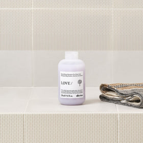 Davines bottle in hand showing size and travel-friendly benefit