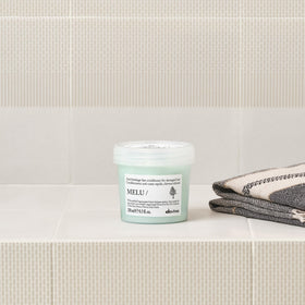 Davines MELU conditioner applied to long hair demonstrating smoothing benefit