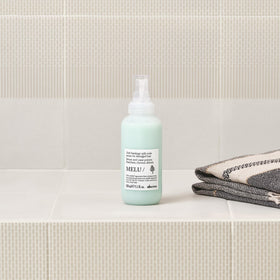 Applying Davines MELU/Serum to midlengths and ends for smoother hair benefit