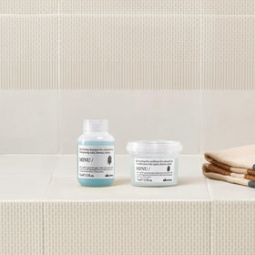 Davines MINU conditioner close-up showing label and smoothing benefit for hair