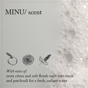 Davines MINU held in hand to show 8.5 fl oz size and portability