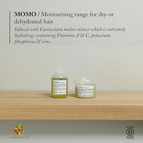 Davines MOMO Conditioner in a travel kit on bathroom shelf for portability