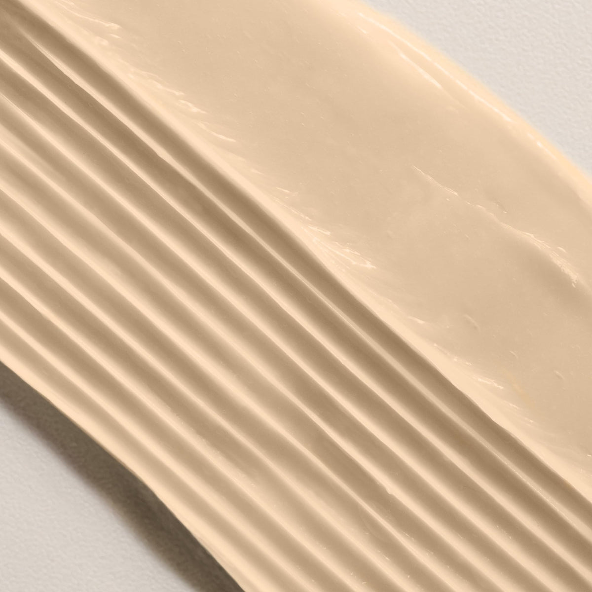 Davines NOUNOU bottle beside an 8.5 oz measure for size comparison