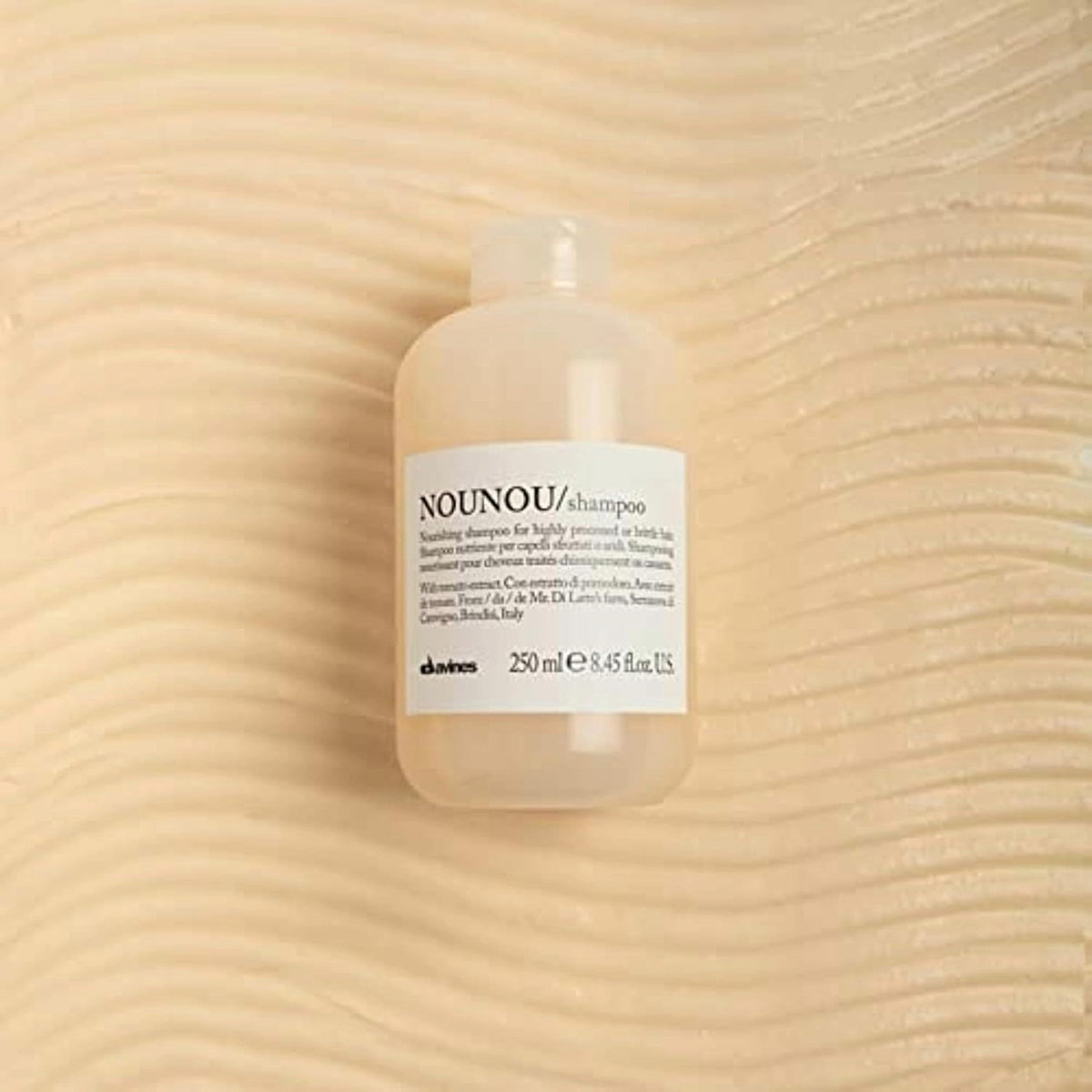 Davines creamy foam texture on hand, demonstrates gentle conditioning lather benefit