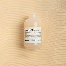 Davines creamy foam texture on hand, demonstrates gentle conditioning lather benefit