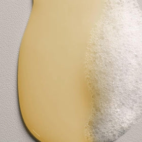 Davines shampoo applied to wet hair in salon, illustrates cleansing and detangling benefit