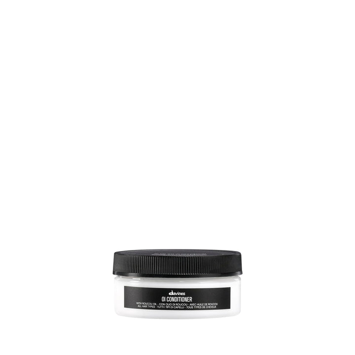 Davines OI Conditioner front packaging shows compact travel bottle and brand benefit