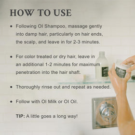 Hand holding Davines OI Conditioner travel size illustrating portability and convenience