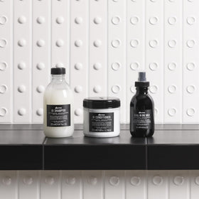 Davines OI conditioner pictured with OI oil and milk to show complementary finish