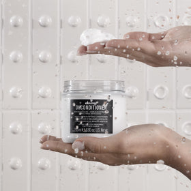 Davines OI hair in use after treatment showing smooth shiny strands and reduced frizz
