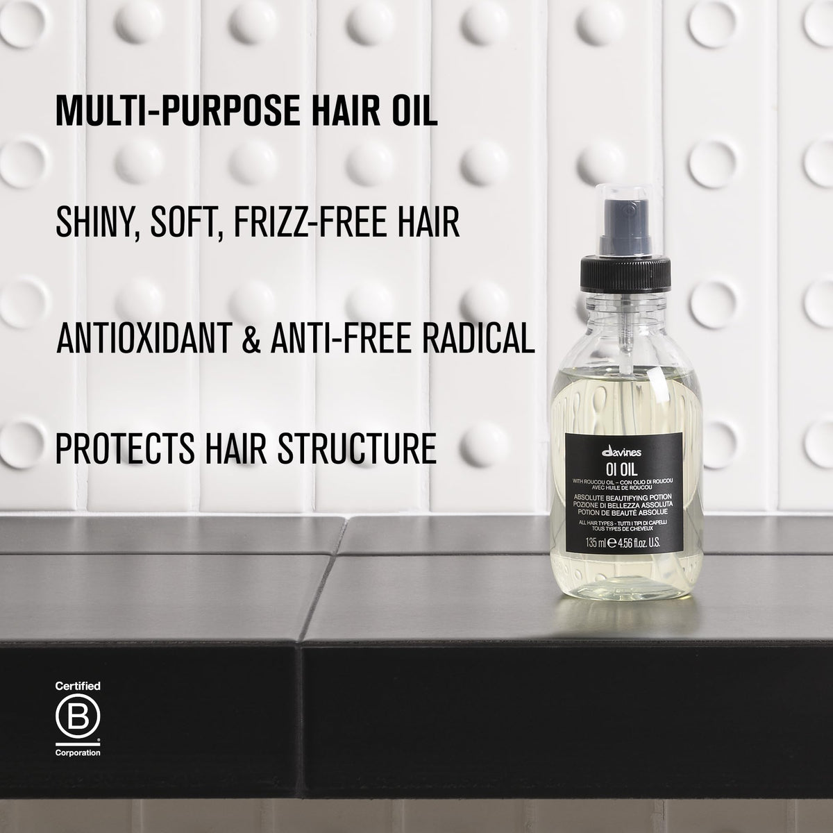 Davines OI Oil applied to wet hair, aiding detangling and faster drying