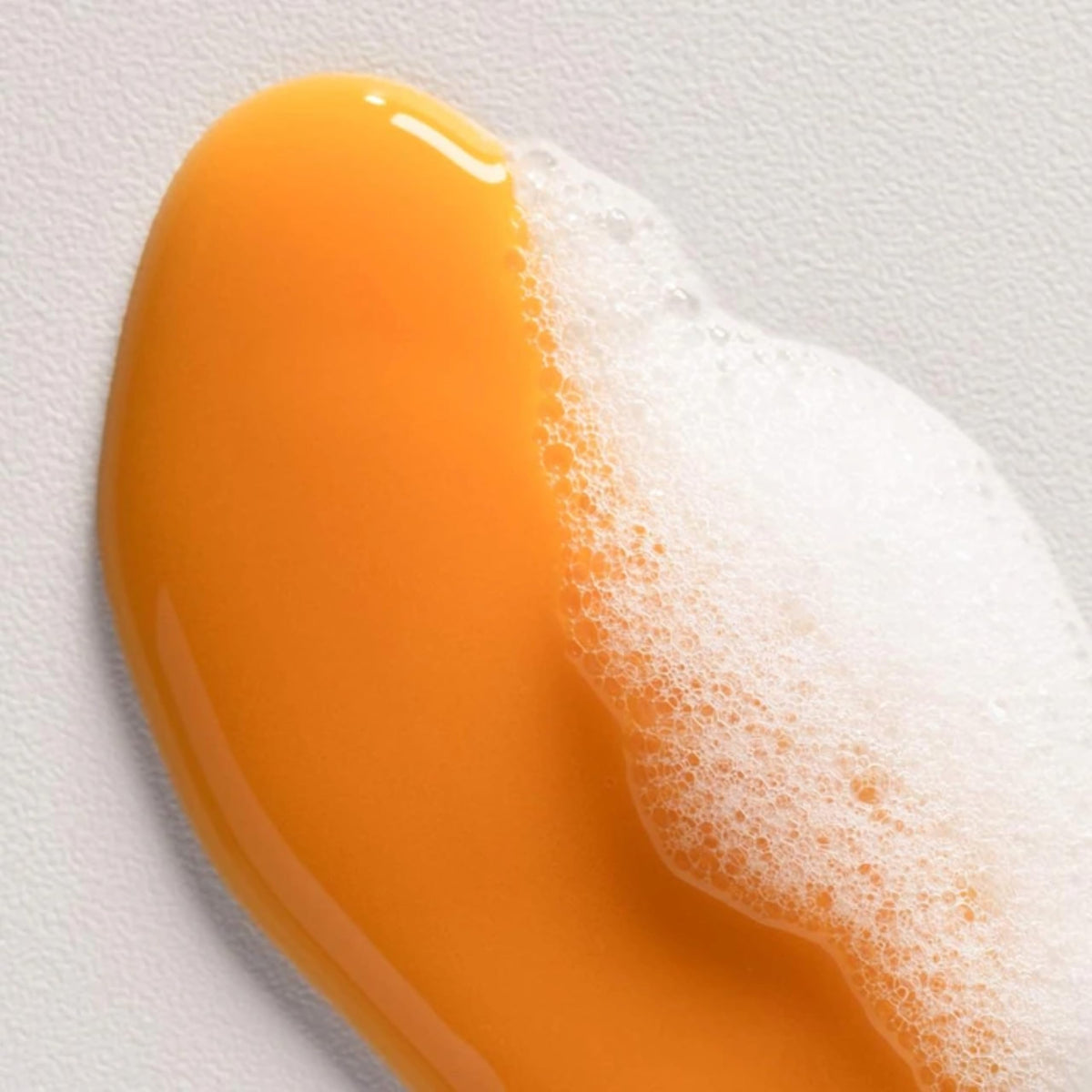 Person using Davines shampoo in shower to clarify and reduce flakes