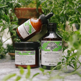 Davines renewing shampoo in shower illustrating in-use cleansing benefit