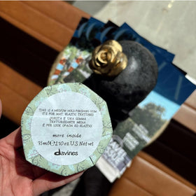 Davines tube beside comb showing size and styling compatibility