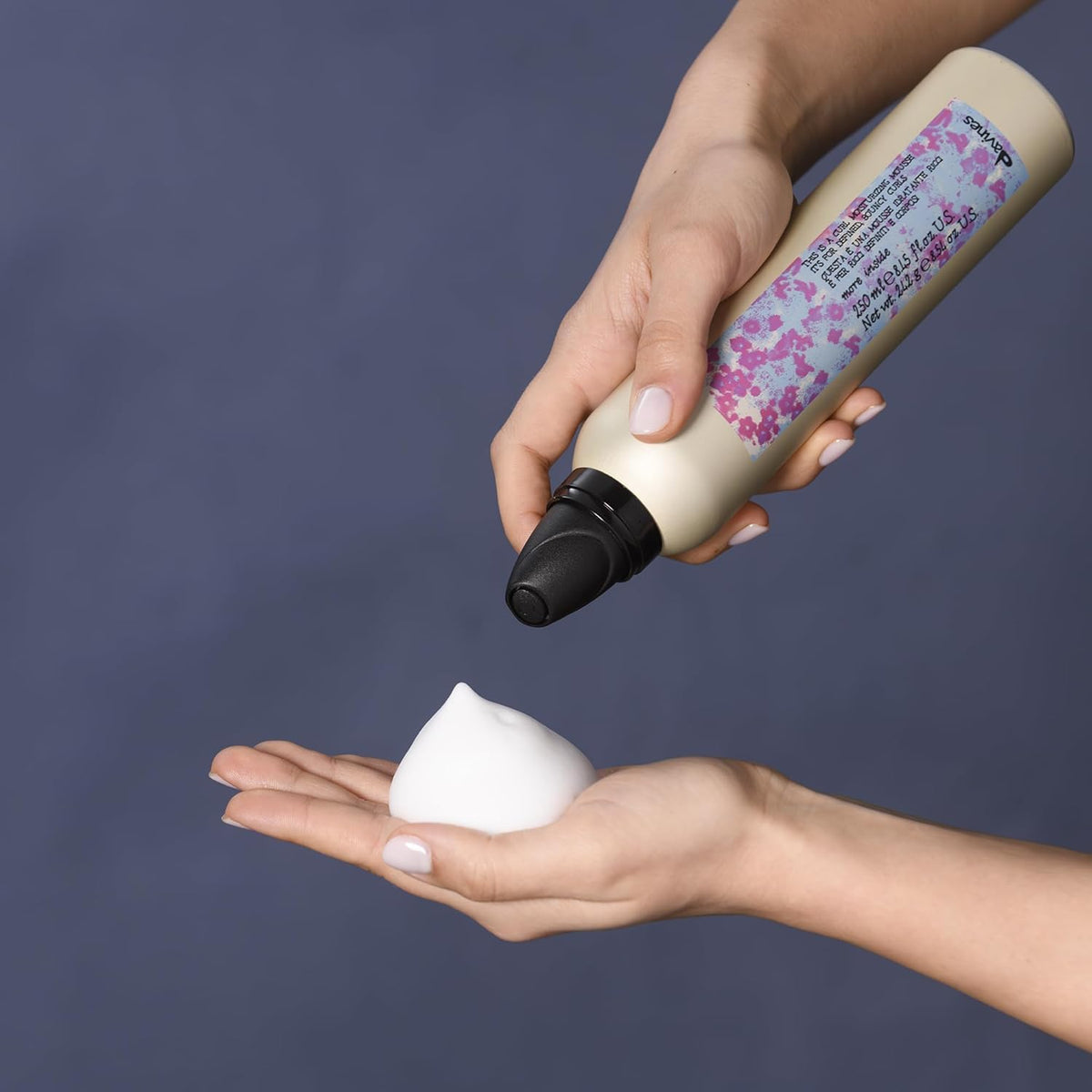 Davines mousse being dispensed into hand showing easy application benefit
